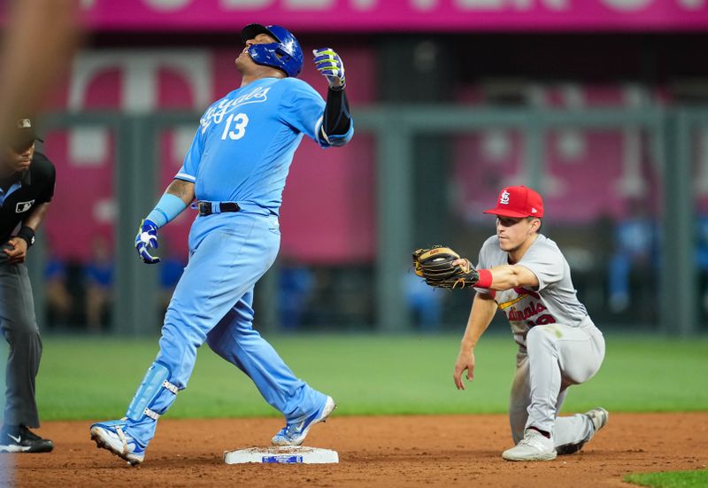 Aug 11, 2023; Kansas City, Missouri, USA; Kansas City Royals catcher Salvador Perez (13) reacts after being tagged out while trying to stretch a single against St. Louis Cardinals shortstop Tommy Edman (19) during the seventh inning at Kauffman Stadium. Mandatory Credit: Jay Biggerstaff-USA TODAY Sports