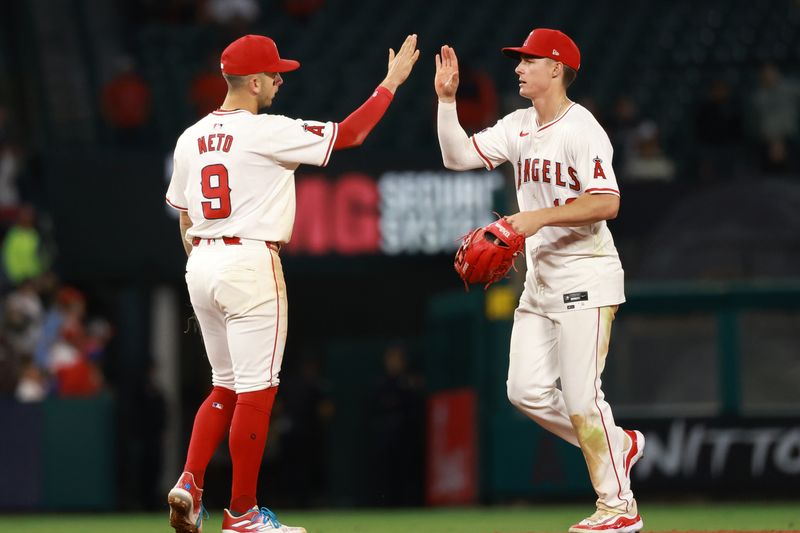 May 15, 2024; Anaheim, California, USA;  Los Angeles Angels shortstop Zach Neto (9) and center fielder Mickey Moniak (16) celebrate a victory after defeating the St. Louis Cardinals 7-2 at Angel Stadium. Mandatory Credit: Kiyoshi Mio-USA TODAY Sports