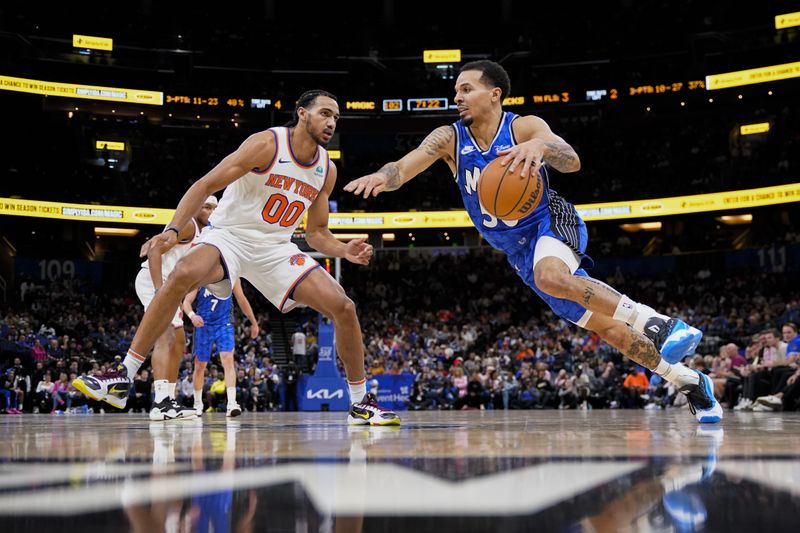 ORLANDO, FLORIDA - FEBRUARY 14: Cole Anthony #50 of the Orlando Magic dribbles the ball against Jacob Toppin #00 of the New York Knicks during the fourth quarter at Kia Center on February 14, 2024 in Orlando, Florida. NOTE TO USER: User expressly acknowledges and agrees that, by downloading and or using this photograph, user is consenting to the terms and conditions of the Getty Images License Agreement. (Photo by Rich Storry/Getty Images)