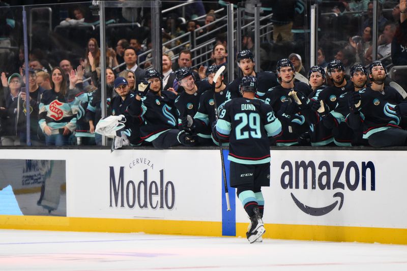 Oct 2, 2024; Seattle, Washington, USA; Seattle Kraken defenseman Vince Dunn (29) celebrates with the bench after scoring a goal against the Edmonton Oilers during the third period at Climate Pledge Arena. Mandatory Credit: Steven Bisig-Imagn Images