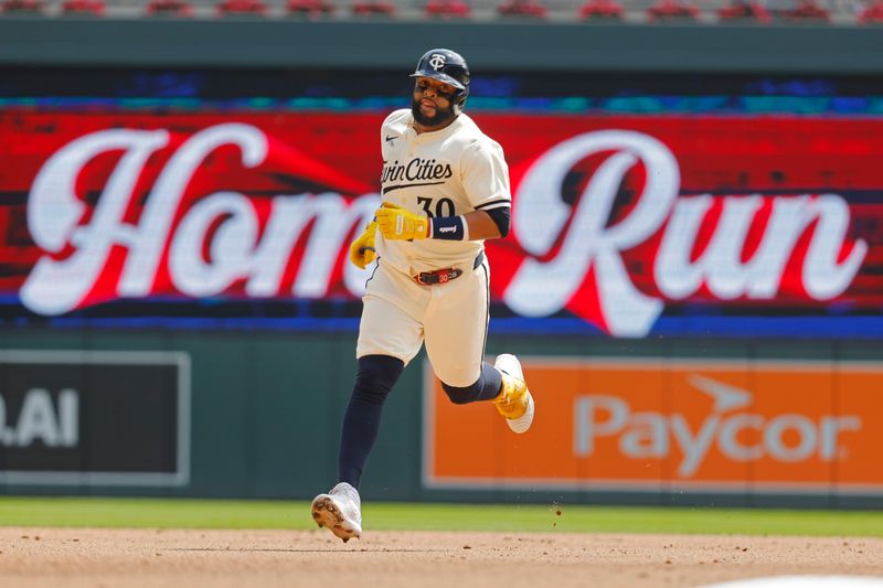 Aug 14, 2024; Minneapolis, Minnesota, USA; Minnesota Twins first baseman Carlos Santana (30) runs the bases after hitting a solo home run against the Kansas City Royals in the fourth inning at Target Field. Mandatory Credit: Bruce Kluckhohn-USA TODAY Sports