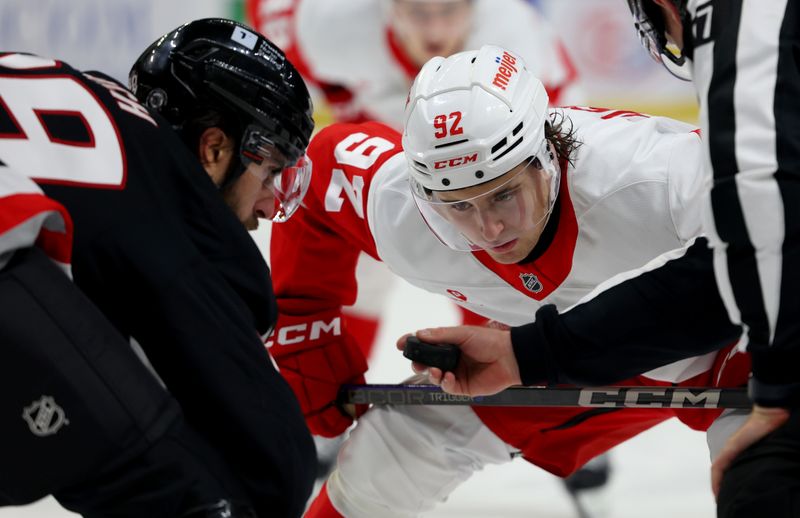 Oct 26, 2024; Buffalo, New York, USA;  Detroit Red Wings center Marco Kasper (92) waits for the linesman to drop the puck for a face-off against Buffalo Sabres right wing Alex Tuch (89) during the third period at KeyBank Center. Mandatory Credit: Timothy T. Ludwig-Imagn Images