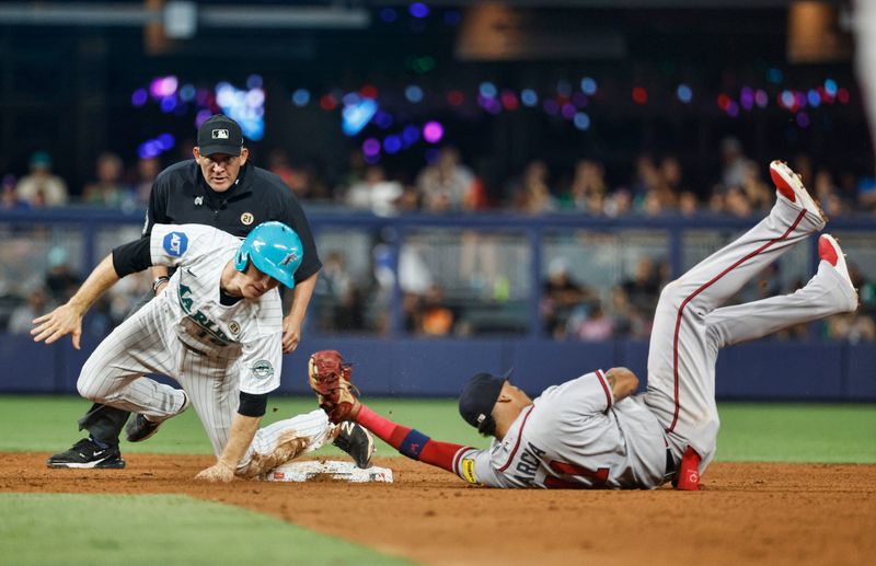 Sep 15, 2023; Miami, Florida, USA; Miami Marlins shortstop Joey Wendle (18) is out at second base on a fielders choice tag by Atlanta Braves shortstop Orlando Arcia (11) during the fourth ining at loanDepot Park. Mandatory Credit: Rhona Wise-USA TODAY Sports