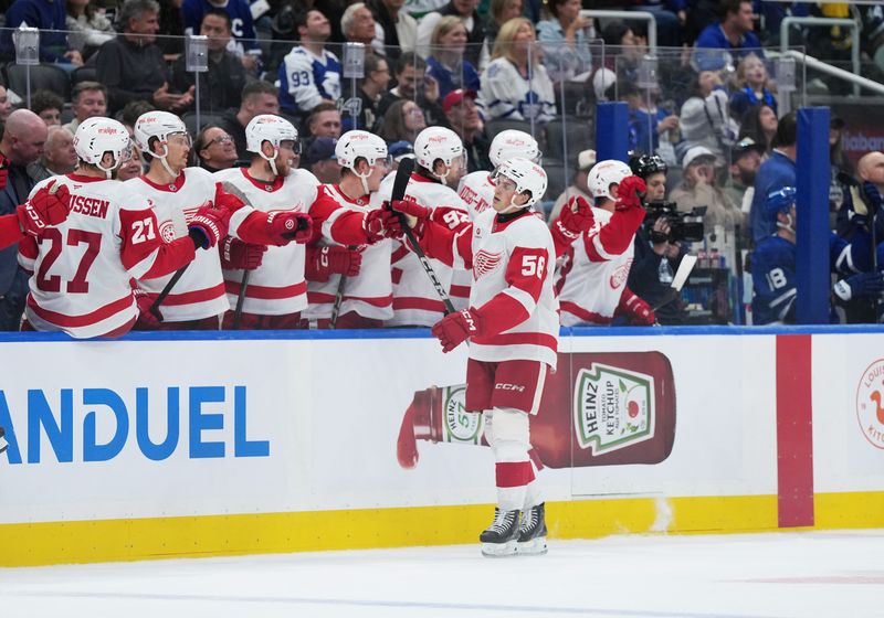 Oct 2, 2025; Toronto, Ontario, CAN; Detroit Red Wings center Emmitt Finnie (58) celebrates at the bench after scoring an empty net goal against the Toronto Maple Leafs during the third period at Scotiabank Arena. Mandatory Credit: Nick Turchiaro-Imagn Images