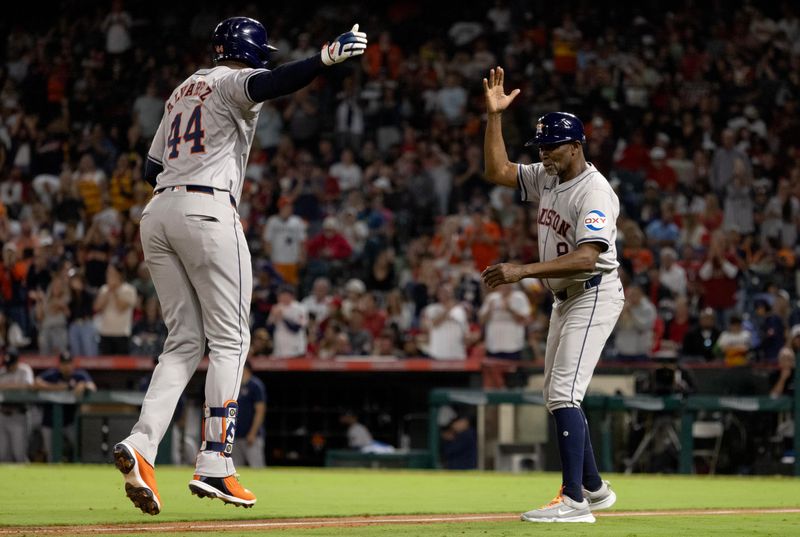 Sep 14, 2024; Anaheim, California, USA; Houston Astros outfielder Yordan Alvarez (44) celebrates with third base coach Gary Pettis (8) after hitting a two-run home run during the 5th inning against the Los Angeles Angels at Angel Stadium. Mandatory Credit: Jason Parkhurst-Imagn Images