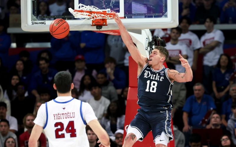 Jan 4, 2025; Dallas, Texas, USA; Duke Blue Devils forward Mason Gillis (18) dunks past Southern Methodist Mustangs center Samet Yigitoglu (24) during the second half at Moody Coliseum. Mandatory Credit: Kevin Jairaj-Imagn Images