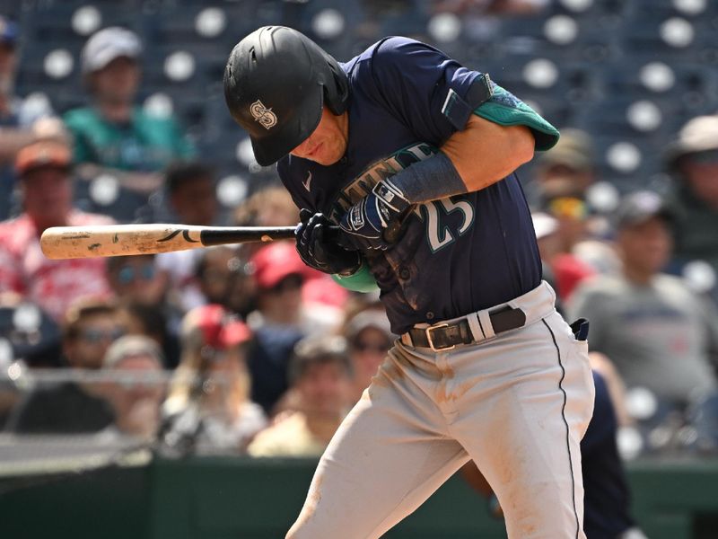 May 26, 2024; Washington, District of Columbia, USA; Seattle Mariners third baseman Dylan Moore (25) gets hit by a Washington Nationals relief pitcher Jordan Weems (51) pitch (not pictured) during the ninth inning at Nationals Park. Mandatory Credit: Rafael Suanes-USA TODAY Sports