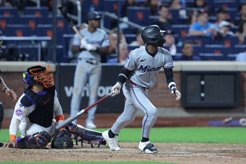 Jun 11, 2024; New York City, New York, USA; Miami Marlins left fielder Nick Gordon (1) follows through on an RBI sacrifice fly against the New York Mets during the ninth inning at Citi Field. Mandatory Credit: Brad Penner-USA TODAY Sports