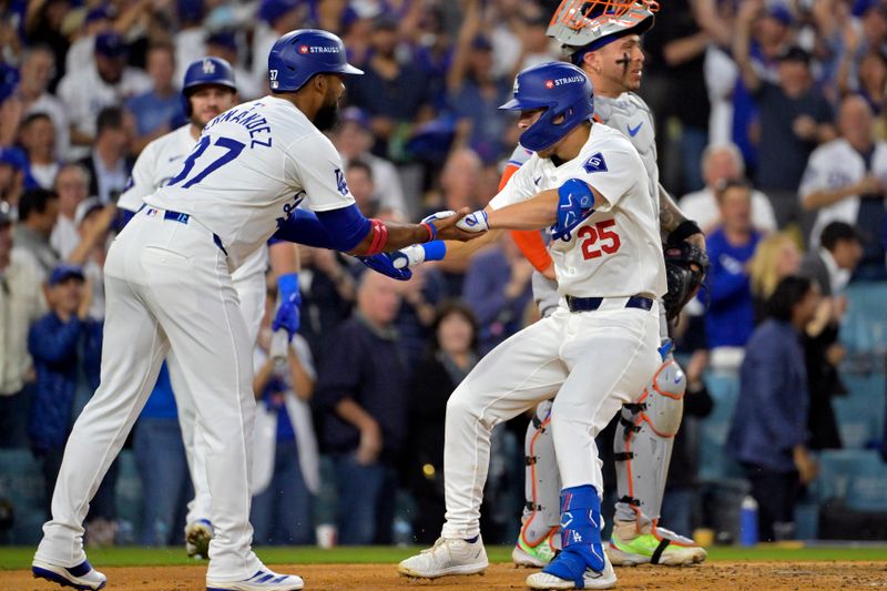 Oct 20, 2024; Los Angeles, California, USA; Los Angeles Dodgers shortstop Tommy Edman (25) celebrates with outfielder Teoscar Hernandez (37) after scoring on a two run home run in the third inning against the New York Mets during game six of the NLCS for the 2024 MLB playoffs at Dodger Stadium. Mandatory Credit: Jayne Kamin-Oncea-Imagn Images