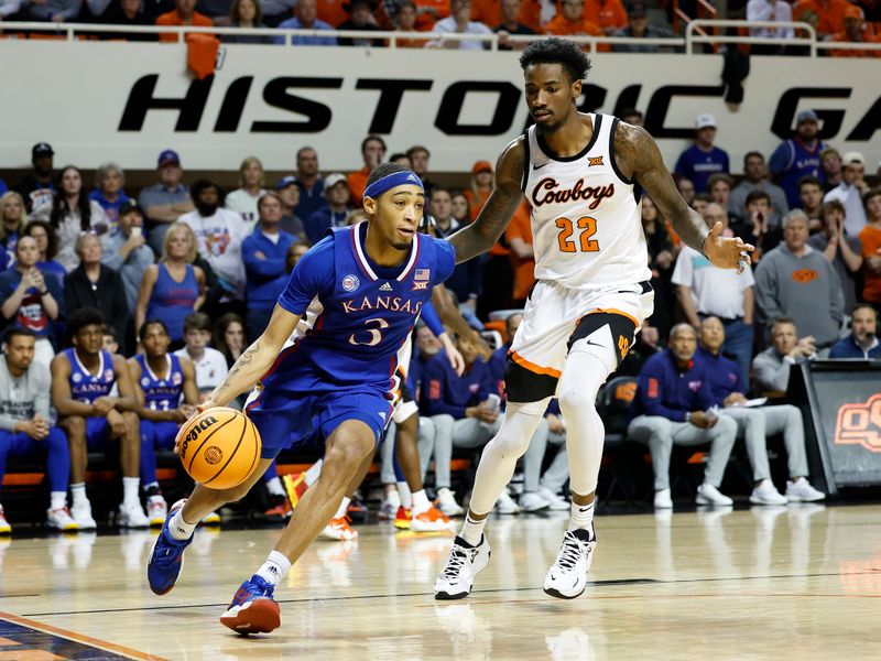 Feb 14, 2023; Stillwater, Oklahoma, USA; Kansas Jayhawks guard Dajuan Harris Jr. (3) drives around Oklahoma State Cowboys forward Kalib Boone (22) during the second half at Gallagher-Iba Arena. Kansas won 87-76. Mandatory Credit: Alonzo Adams-USA TODAY Sports