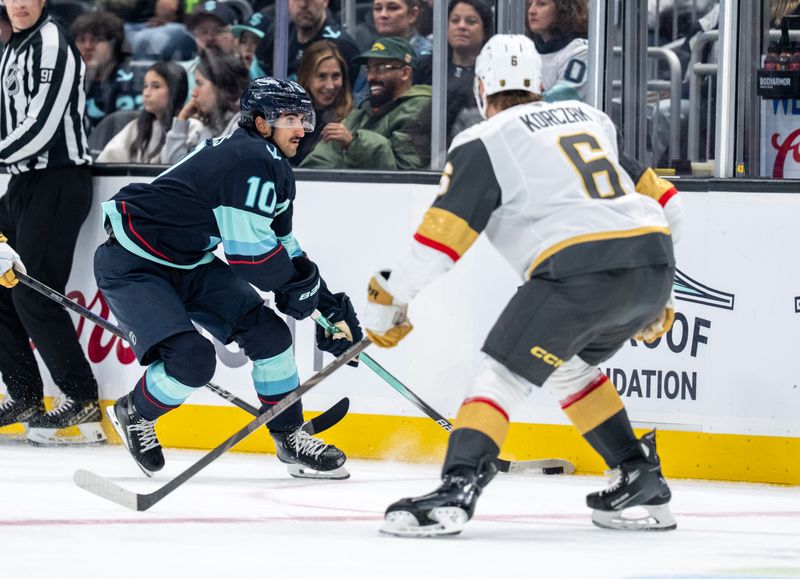 Oct 11, 2025; Seattle, Washington, USA; Seattle Kraken forward Matty Beniers (10) skates against Vegas Golden Knights defenseman Kaedan Korczak (6) during the second period at Climate Pledge Arena. Mandatory Credit: Stephen Brashear-Imagn Images