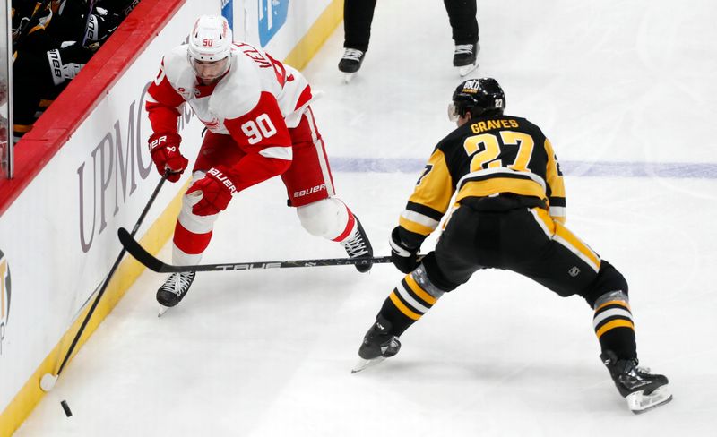 Mar 17, 2024; Pittsburgh, Pennsylvania, USA;  Detroit Red Wings center Joe Veleno (90) moves the puck against Pittsburgh Penguins defenseman Ryan Graves (27) during the third period at PPG Paints Arena. Pittsburgh won 6-3. Mandatory Credit: Charles LeClaire-USA TODAY Sports