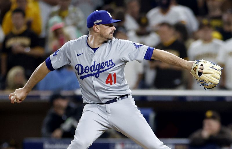 Oct 9, 2024; San Diego, California, USA; Los Angeles Dodgers pitcher Daniel Hudson (41) throws in the seventh inning against the San Diego Padres during game four of the NLDS for the 2024 MLB Playoffs at Petco Park. Mandatory Credit: David Frerker-Imagn Images