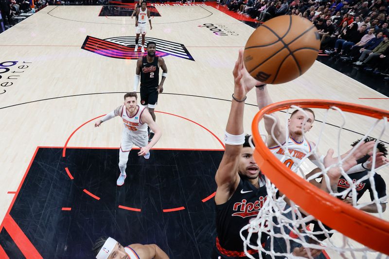 PORTLAND, OREGON - MARCH 14: Toumani Camara #33 (L) of the Portland Trail Blazers shoots the ball against Donte DiVincenzo #0 of the New York Knicks during the first half at Moda Center on March 14, 2024 in Portland, Oregon. NOTE TO USER: User expressly acknowledges and agrees that, by downloading and or using this photograph, User is consenting to the terms and conditions of the Getty Images License Agreement.  (Photo by Soobum Im/Getty Images)