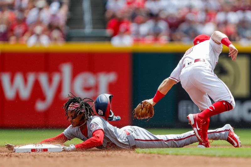 Aug 6, 2023; Cincinnati, Ohio, USA; Cincinnati Reds second baseman Matt McLain (9) attempts to tag out Washington Nationals shortstop CJ Abrams (5) at second in the second inning at Great American Ball Park. Mandatory Credit: Katie Stratman-USA TODAY Sports