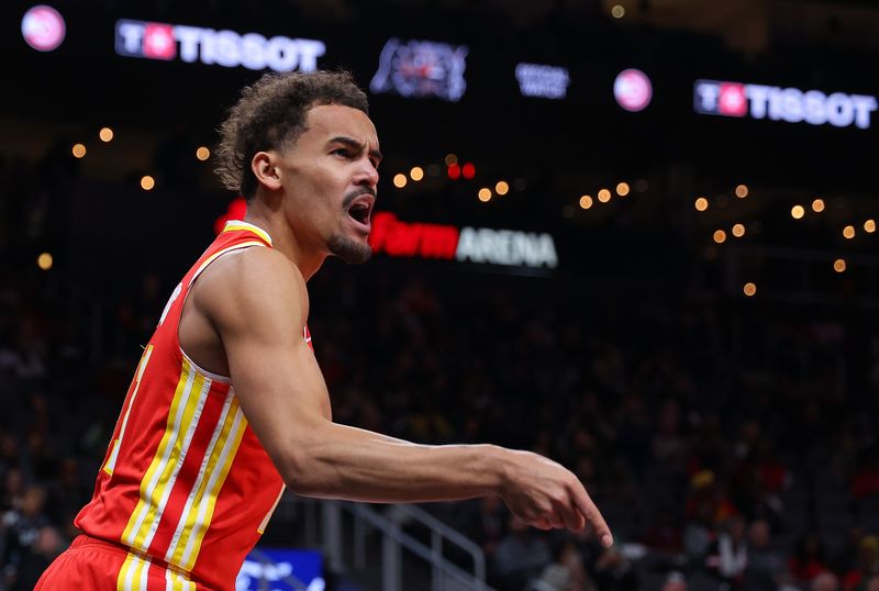 ATLANTA, GEORGIA - DECEMBER 06:  Trae Young #11 of the Atlanta Hawks reacts after drawing a foul on a basket against the Brooklyn Nets during the first quarter at State Farm Arena on December 06, 2023 in Atlanta, Georgia.  NOTE TO USER: User expressly acknowledges and agrees that, by downloading and/or using this photograph, user is consenting to the terms and conditions of the Getty Images License Agreement.  (Photo by Kevin C. Cox/Getty Images)