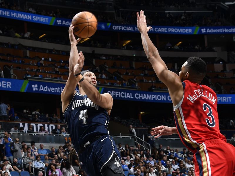 ORLANDO, FL - MARCH 21: Jalen Suggs #4 of the Orlando Magic looks to pass the ball during the game against the New Orleans Pelicans on March 21, 2024 at Amway Center in Orlando, Florida. NOTE TO USER: User expressly acknowledges and agrees that, by downloading and or using this photograph, User is consenting to the terms and conditions of the Getty Images License Agreement. Mandatory Copyright Notice: Copyright 2024 NBAE (Photo by Fernando Medina/NBAE via Getty Images)