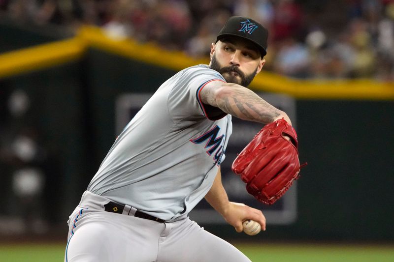 May 26, 2024; Phoenix, Arizona, USA; Miami Marlins pitcher Tanner Scott (66) throws against the Arizona Diamondbacks in the ninth inning at Chase Field. Mandatory Credit: Rick Scuteri-USA TODAY Sports