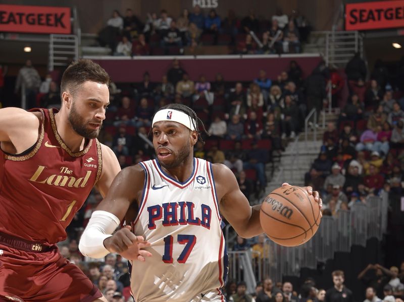 CLEVELAND, OH - FEBRUARY 12: Buddy Heild #17 of the Philadelphia 76ers drives to the basket against Max Strus #1 of the Cleveland Cavaliers during the game on February 12, 2024 at Rocket Mortgage FieldHouse in Cleveland, Ohio. NOTE TO USER: User expressly acknowledges and agrees that, by downloading and/or using this Photograph, user is consenting to the terms and conditions of the Getty Images License Agreement. Mandatory Copyright Notice: Copyright 2024 NBAE (Photo by David Liam Kyle/NBAE via Getty Images)