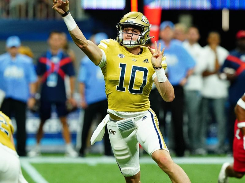 Sep 1, 2023; Atlanta, Georgia, USA; Georgia Tech Yellow Jackets quarterback Haynes King (10) rolls out to pass against the Louisville Cardinals during the first quarter at Mercedes-Benz Stadium. Mandatory Credit: John David Mercer-USA TODAY Sports