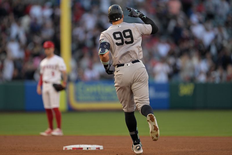 May 30, 2024; Anaheim, California, USA;  New York Yankees center fielder Aaron Judge (99) rounds the bases on a two-run home run scoring right fielder Juan Soto (22) in the fourth inning against the Los Angeles Angels at Angel Stadium. Mandatory Credit: Jayne Kamin-Oncea-USA TODAY Sports