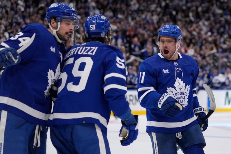 Apr 24, 2024; Toronto, Ontario, CAN; Toronto Maple Leafs forward Auston Matthews (34) and forward Max Domi (11) congratulate forward Tyler Bertuzzi (59) on his goal against the Boston Bruins during the third period of game three of the first round of the 2024 Stanley Cup Playoffs at Scotiabank Arena. Mandatory Credit: John E. Sokolowski-USA TODAY Sports