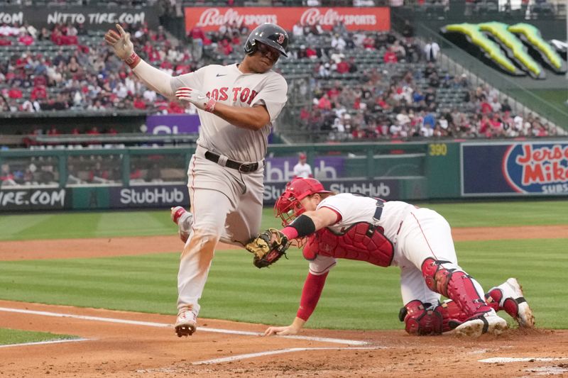 May 24, 2023; Anaheim, California, USA; Boston Red Sox third baseman Rafael Devers (11) is tagged out at home plate by Los Angeles Angels catcher Chad Wallach (35) in the second inning at Angel Stadium. Mandatory Credit: Kirby Lee-USA TODAY Sports