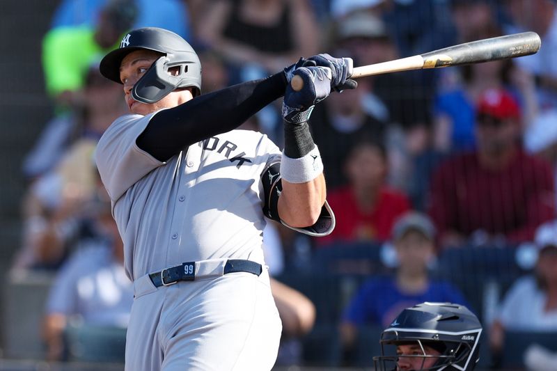 Apr 19, 2025; Tampa, Florida, USA; New York Yankees right fielder Aaron Judge (99) hits a two rbi single against the Tampa Bay Rays in the fourth inning at George M. Steinbrenner Field. Mandatory Credit: Nathan Ray Seebeck-Imagn Images
