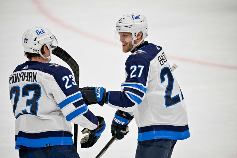 Apr 11, 2024; Dallas, Texas, USA; Winnipeg Jets center Sean Monahan (23) and left wing Nikolaj Ehlers (27) celebrates a goal scored by Ehlers against the Dallas Stars and during the first period at the American Airlines Center. Mandatory Credit: Jerome Miron-USA TODAY Sports