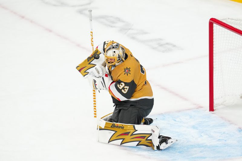 Oct 8, 2025; Las Vegas, Nevada, USA; Vegas Golden Knights goaltender Adin Hill (33) makes a save against the Los Angeles Kings during an overtime period at T-Mobile Arena. Mandatory Credit: Stephen R. Sylvanie-Imagn Images