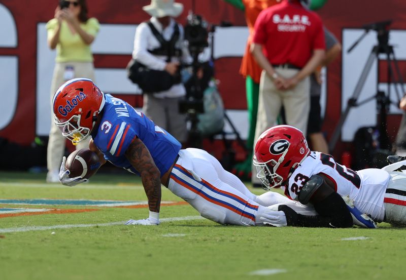 Oct 28, 2023; Jacksonville, Florida, USA; Florida Gators wide receiver Eugene Wilson III (3) runs past Georgia Bulldogs defensive back Tykee Smith (23) for a touchdown during the first quarter at EverBank Stadium. Mandatory Credit: Kim Klement Neitzel-USA TODAY Sports