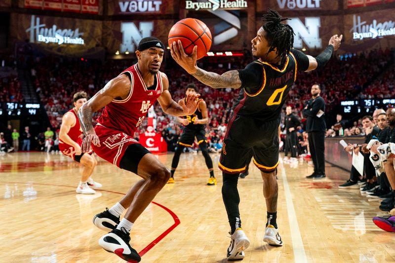 Feb 25, 2024; Lincoln, Nebraska, USA; Minnesota Golden Gophers guard Elijah Hawkins (0) grabs a loose ball against Nebraska Cornhuskers guard Jamarques Lawrence (10) during the second half at Pinnacle Bank Arena. Mandatory Credit: Dylan Widger-USA TODAY Sports