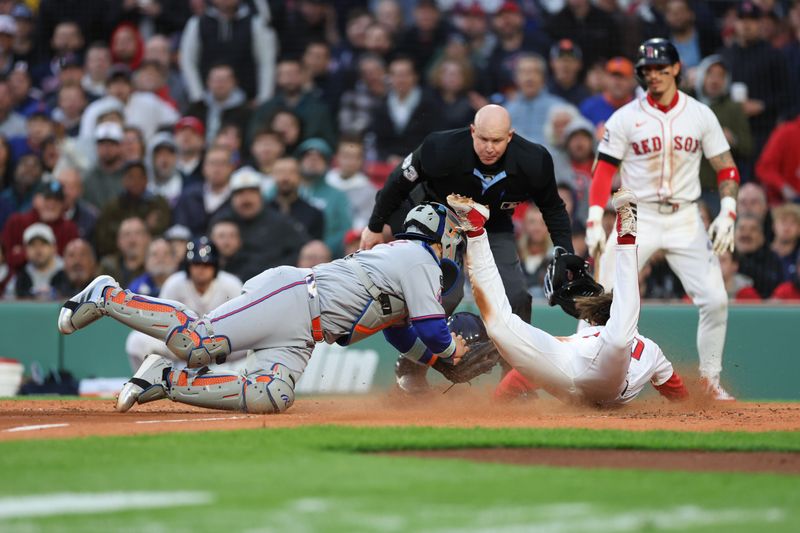 May 20, 2025; Boston, Massachusetts, USA; New York Mets catcher Francisco Alvarez (4) tags out Boston Red Sox first baseman Nick Sogard (20) at home plate during the second inning at Fenway Park. Mandatory Credit: Paul Rutherford-Imagn Images