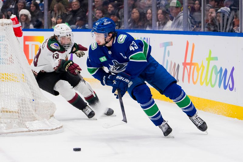 Jan 18, 2024; Vancouver, British Columbia, CAN; Arizona Coyotes forward Matias Maccelli (63) pursues Vancouver Canucks defenseman Quinn Hughes (43) in the first period at Rogers Arena. Mandatory Credit: Bob Frid-USA TODAY Sports