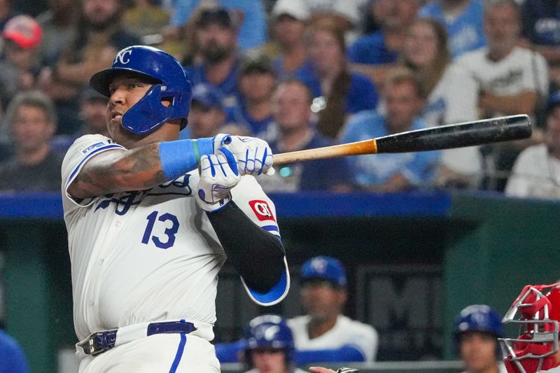Aug 19, 2024; Kansas City, Missouri, USA; Kansas City Royals catcher Salvador Perez (13) hits a two-run double against the Los Angeles Angels in the seventh inning at Kauffman Stadium. Mandatory Credit: Denny Medley-USA TODAY Sports
