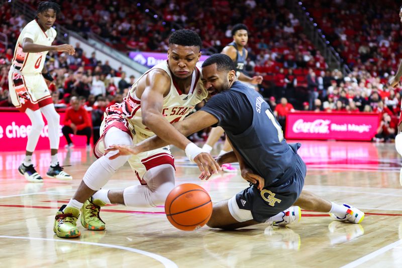 Feb 4, 2023; Raleigh, North Carolina, USA; North Carolina State Wolfpack guard Casey Morsell (14) and Georgia Tech Yellow Jackets guard Kyle Sturdivant (1) battle for the ball during the second half of the game at PNC Arena. Mandatory Credit: Jaylynn Nash-USA TODAY Sports