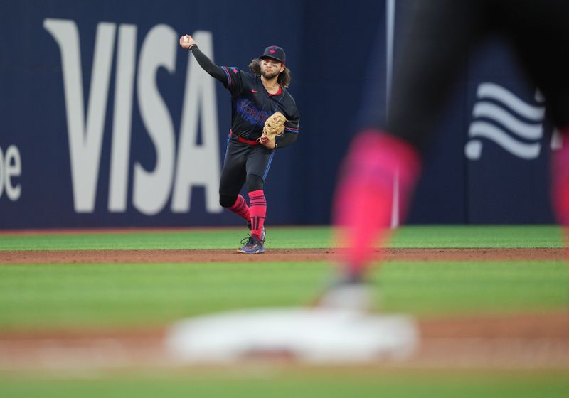 Jun 3, 2024; Toronto, Ontario, CAN; Toronto Blue Jays shortstop Bo Bichette (11) throws a ball to first base causing a throwing error against the Baltimore Orioles during the fifth inning at Rogers Centre. Mandatory Credit: Nick Turchiaro-USA TODAY Sports