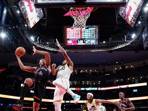 TORONTO, ON - DECEMBER 23: Scottie Barnes #4 of the Toronto Raptors goes to the basket against Ochai Agbaji #30 of the Utah Jazz during the second half of their basketball game at the Scotiabank Arena on December 23, 2023 in Toronto, Ontario, Canada. NOTE TO USER: User expressly acknowledges and agrees that, by downloading and/or using this Photograph, user is consenting to the terms and conditions of the Getty Images License Agreement. (Photo by Mark Blinch/Getty Images)