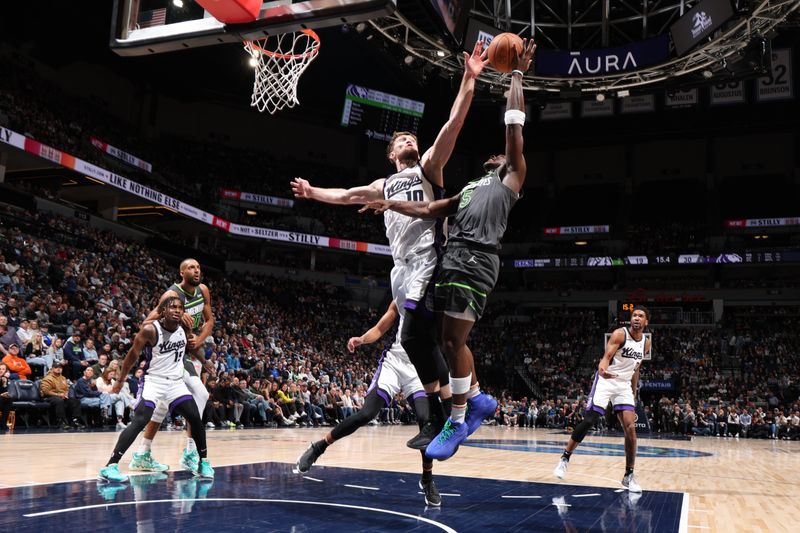 MINNEAPOLIS, MN -  MARCH 1: Anthony Edwards #5 of the Minnesota Timberwolves shoots the ball while Domantas Sabonis #10 of the Sacramento Kings goes up for the block during the game on March 1, 2024 at Target Center in Minneapolis, Minnesota. NOTE TO USER: User expressly acknowledges and agrees that, by downloading and or using this Photograph, user is consenting to the terms and conditions of the Getty Images License Agreement. Mandatory Copyright Notice: Copyright 2024 NBAE (Photo by David Sherman/NBAE via Getty Images)