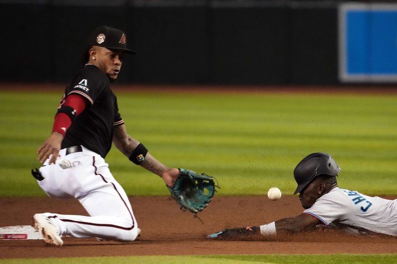 May 9, 2023; Phoenix, Arizona, USA; Miami Marlins center fielder Jazz Chisholm Jr. (2) slides into second base safely for a steal ahead of a throw to Arizona Diamondbacks second baseman Ketel Marte (4) during the fifth inning at Chase Field. Mandatory Credit: Joe Camporeale-USA TODAY Sports