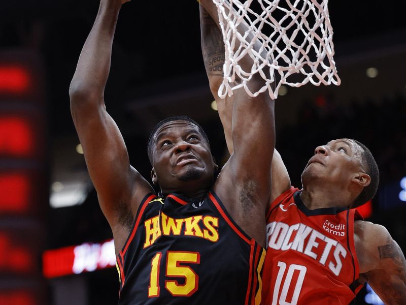 HOUSTON, TEXAS - DECEMBER 20: Clint Capela #15 of the Atlanta Hawks drives to the net ahead of Jabari Smith Jr. #10 of the Houston Rockets during the first half at Toyota Center on December 20, 2023 in Houston, Texas. User expressly acknowledges and agrees that, by downloading and or using this photograph, User is consenting to the terms and conditions of the Getty Images License Agreement.?  (Photo by Carmen Mandato/Getty Images)