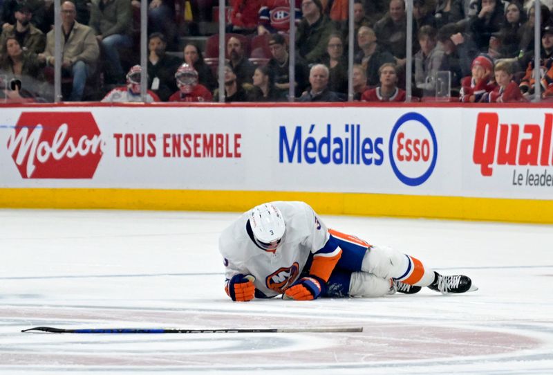 Jan 25, 2024; Montreal, Quebec, CAN; New York Islanders defenseman Adam Pelech (3) lays on the ice after an apparent injury during the third period of the game against the Montreal Canadiens at the Bell Centre. Mandatory Credit: Eric Bolte-USA TODAY Sports