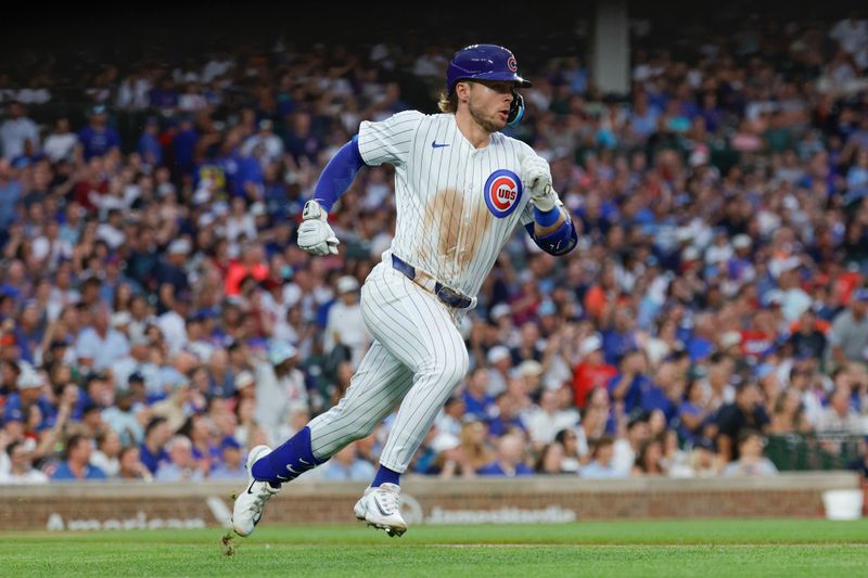 Aug 1, 2024; Chicago, Illinois, USA; Chicago Cubs second baseman Nico Hoerner (2) runs after hitting a single against the St. Louis Cardinals during the second inning at Wrigley Field. Mandatory Credit: Kamil Krzaczynski-USA TODAY Sports