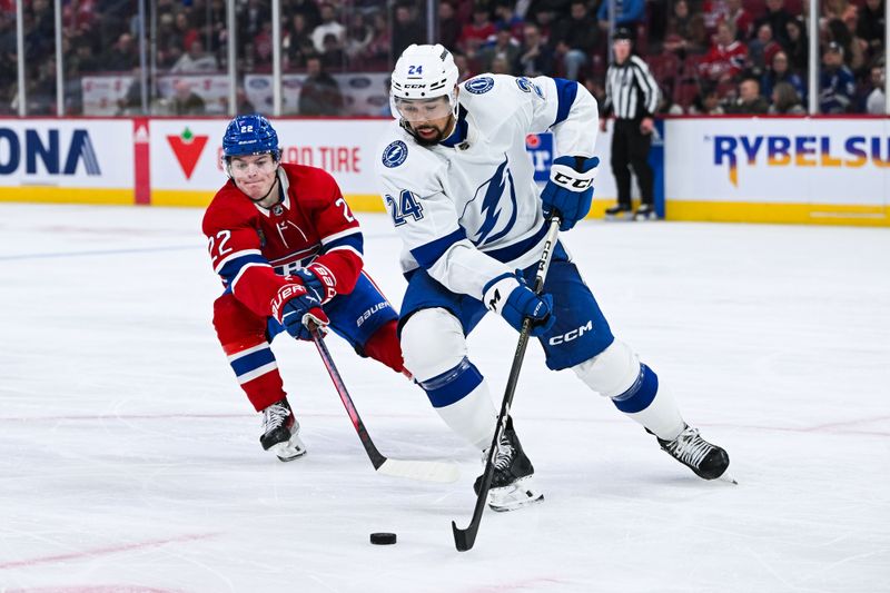 Apr 4, 2024; Montreal, Quebec, CAN; Tampa Bay Lightning defenseman Mathew Dumba (24) defends the puck against Montreal Canadiens right wing Cole Caufield (22) during the third period at Bell Centre. Mandatory Credit: David Kirouac-USA TODAY Sports