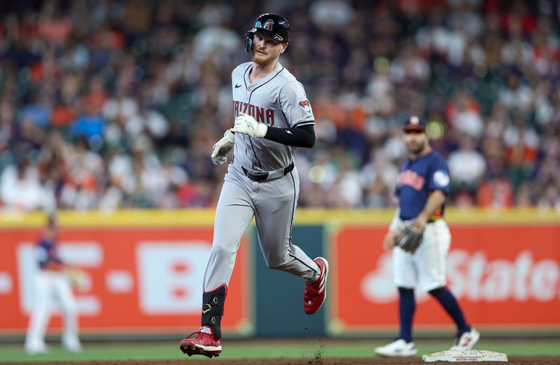 Sep 8, 2024; Houston, Texas, USA; Houston Astros second baseman Jose Altuve (27) reacts and Arizona Diamondbacks left fielder Pavin Smith (26) rounds second base after hitting a grand slam home run during the third inning at Minute Maid Park. Mandatory Credit: Troy Taormina-Imagn Images