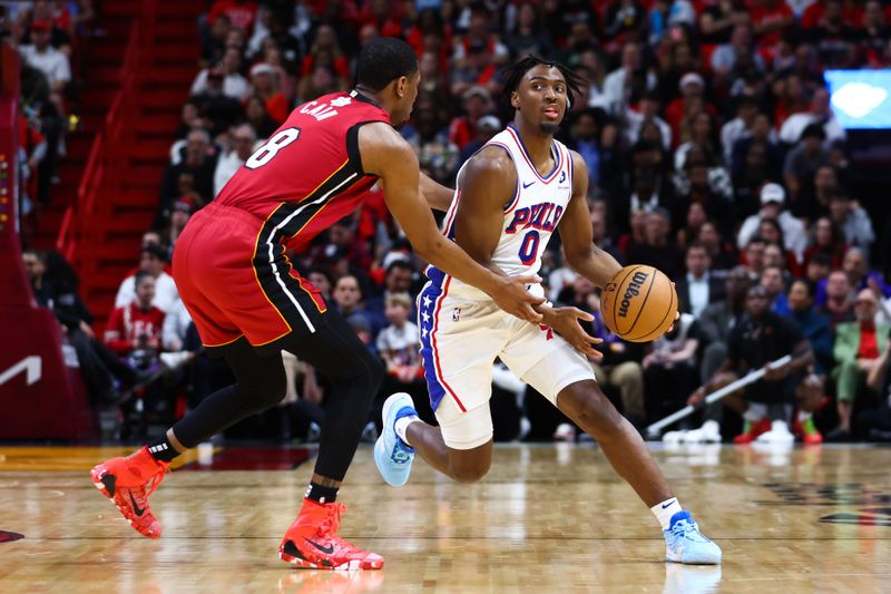 MIAMI, FLORIDA - DECEMBER 25: Tyrese Maxey #0 of the Philadelphia 76ers drives against Jamal Cain #8 of the Miami Heat during the first quarter of the game at Kaseya Center on December 25, 2023 in Miami, Florida. NOTE TO USER: User expressly acknowledges and agrees that, by downloading and or using this photograph, User is consenting to the terms and conditions of the Getty Images License Agreement. (Photo by Megan Briggs/Getty Images)