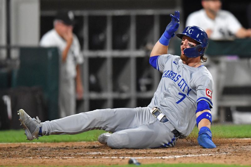 Jul 30, 2024; Chicago, Illinois, USA; Kansas City Royals shortstop Bobby Witt Jr. (7) slides into home plate to score a run during the eighth inning against the Chicago White Sox at Guaranteed Rate Field. Mandatory Credit: Patrick Gorski-USA TODAY Sports