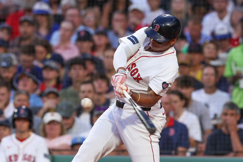 Jun 24, 2024; Boston, Massachusetts, USA; Boston Red Sox third baseman Rafael Devers (11) hits a two run home run during the fourth inning against the Toronto Blue Jays at Fenway Park. Mandatory Credit: Paul Rutherford-USA TODAY Sports