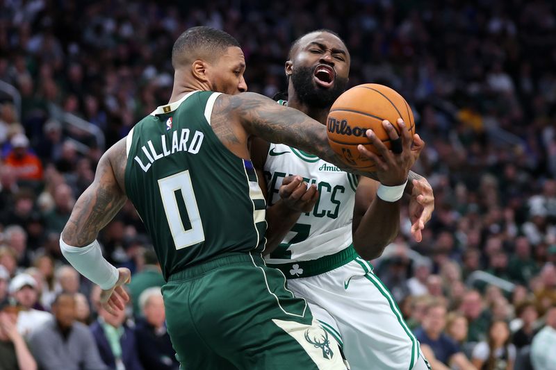 MILWAUKEE, WISCONSIN - NOVEMBER 10: Jaylen Brown #7 of the Boston Celtics is fouled by Damian Lillard #0 of the Milwaukee Bucks during the second half of a game at Fiserv Forum on November 10, 2024 in Milwaukee, Wisconsin. NOTE TO USER: User expressly acknowledges and agrees that, by downloading and or using this photograph, User is consenting to the terms and conditions of the Getty Images License Agreement. (Photo by Stacy Revere/Getty Images)