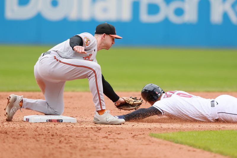 Sep 24, 2023; Cleveland, Ohio, USA; Baltimore Orioles second baseman Jordan Westburg (11) tags out Cleveland Guardians second baseman Andres Gimenez (0) attempting to steal second base during the seventh inning at Progressive Field. Mandatory Credit: Aaron Josefczyk-USA TODAY Sports